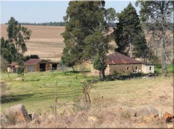 House and outbuildings. Looking from the West.